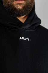 Black AFLETE New Era tracksuit 001, hoodie chest logo close up