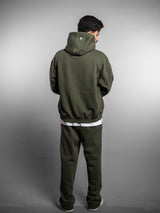 Model wearing the forest green AFLETE New Era joggers 003, joggers rear view