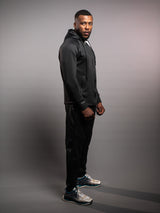 Model wearing the black AFLETE Tech Series tracksuit 005, full outfit rear three quarter view