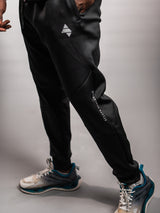 Black AFLETE Tech Series tracksuit 005, joggers leg wordmark close up