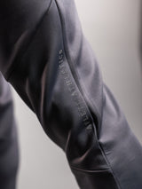 Grey AFLETE Tech Series tracksuit 005, joggers leg wordmark close up