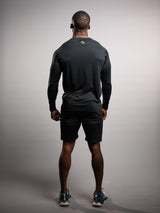 Model wearing the black AFLETE long-sleeve workout set 006, full outfit back view