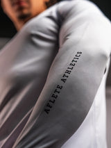 White AFLETE long-sleeve gym shirt 008, sleeve wordmark close up