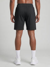 Model wearing the black AFLETE Essential Urban shorts 012, shorts back view