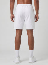 Model wearing the white AFLETE Essential Urban shorts 012, shorts back view