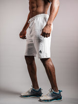 Model wearing the white AFLETE Essential Urban shorts 012, shorts three quarter view