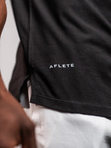 Black AFLETE GYMAHOLIC gym tank top 013, hem logo close up