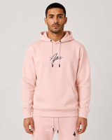 Model wearing the salmon AFLETE Urban hoodie 016, hoodie front hands in pockets