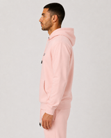 Model wearing the salmon AFLETE Urban hoodie 016, hoodie side view