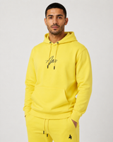 Model wearing the yellow AFLETE Urban hoodie 016, hoodie front hands in pockets
