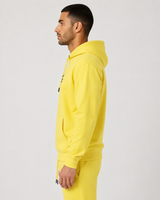 Model wearing the yellow AFLETE Urban hoodie 016, hoodie side view
