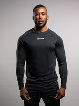 Man wearing a black athletic outfit with 'AFLETE' branding on a gray background