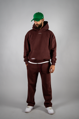 Model wearing the burgundy AFLETE New Era tracksuit 001, full outfit front view