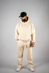 Model wearing the desert beige AFLETE New Era tracksuit 001, full outfit front view