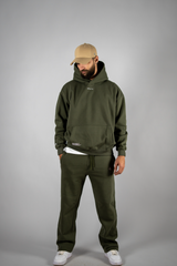 Model wearing the forest green AFLETE New Era tracksuit 001, full outfit front view