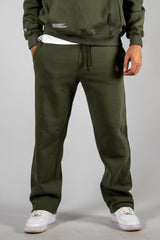 Model wearing the forest green AFLETE New Era tracksuit 001, joggers front view