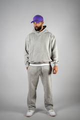 Model wearing the grey AFLETE New Era tracksuit 001, full outfit front view