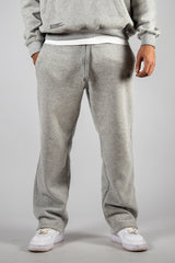 Model wearing the grey AFLETE New Era tracksuit 001, joggers front view