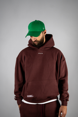 Model wearing the burgundy AFLETE New Era hoodie 002, hoodie front view