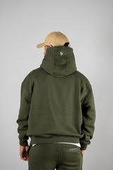 Model wearing the forest green AFLETE New Era hoodie 002, hoodie back view