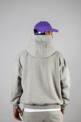 Model wearing the grey AFLETE New Era hoodie 002, hoodie back view