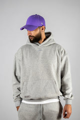 Model wearing the grey AFLETE New Era hoodie 002, hoodie front view