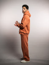 Model wearing the blaze orange AFLETE New Era joggers 003, joggers rear view