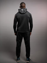 Model wearing the black AFLETE Tech Series tracksuit 005, full outfit back view