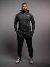Model wearing the black AFLETE Tech Series tracksuit 005, full outfit front view