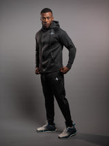 Model wearing the black AFLETE Tech Series tracksuit 005, full outfit side view