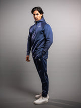 Model wearing the midnight blue AFLETE Tech Series tracksuit 005, full outfit side view