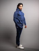 Model wearing the midnight blue AFLETE Tech Series tracksuit 005, full outfit three quarter view