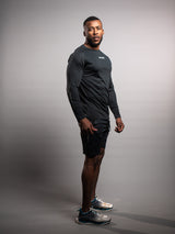 Model wearing the black AFLETE long-sleeve workout set 006, full outfit three quarter view