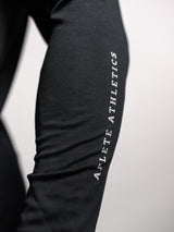 Black AFLETE long-sleeve workout set 006, shorts side wordmark close up