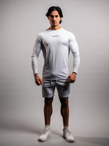 Model wearing the white AFLETE long-sleeve workout set 006, full outfit front view