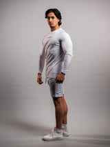 Model wearing the white AFLETE long-sleeve workout set 006, full outfit side view