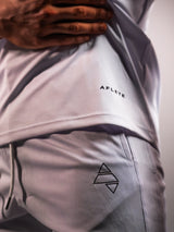 White AFLETE long-sleeve workout set 006, shirt and shorts logo detail