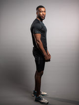Model wearing the black AFLETE short-sleeve workout set 007, full outfit three quarter view