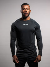 Model wearing the black AFLETE long-sleeve gym shirt 008, shirt front view