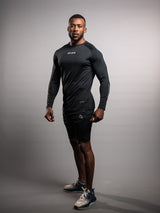 Model wearing the black AFLETE long-sleeve gym shirt 008, shirt three quarter view