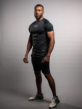 Model wearing the black AFLETE short-sleeve gym shirt 009, shirt three quarter view