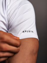 Model wearing the white AFLETE short-sleeve gym shirt 009, shirt back view
