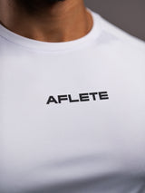 Model wearing the white AFLETE short-sleeve gym shirt 009, shirt side view