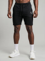 Model wearing the black AFLETE Tech Series gym shorts 010, shorts front view