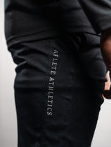 Black AFLETE Tech Series gym shorts 010, side wordmark close up