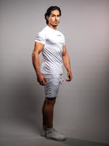 Model wearing the white AFLETE Tech Series gym shorts 010, shorts on model side view