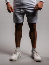 Model wearing the white AFLETE Tech Series gym shorts 010, shorts three quarter view