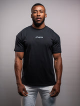 Model wearing the black AFLETE Essential Urban T-shirt 011, tshirt front view