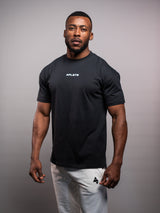 Model wearing the black AFLETE Essential Urban T-shirt 011, tshirt three quarter view