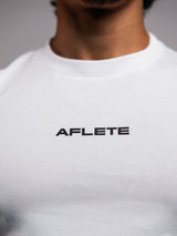 White AFLETE Essential Urban T-shirt 011, back neck logo close up